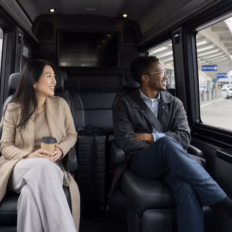 Passengers loading luggage while boarding an Washington group shuttle