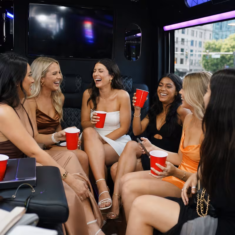 Party bus interior with wraparound leather seating and LED lighting in Washington