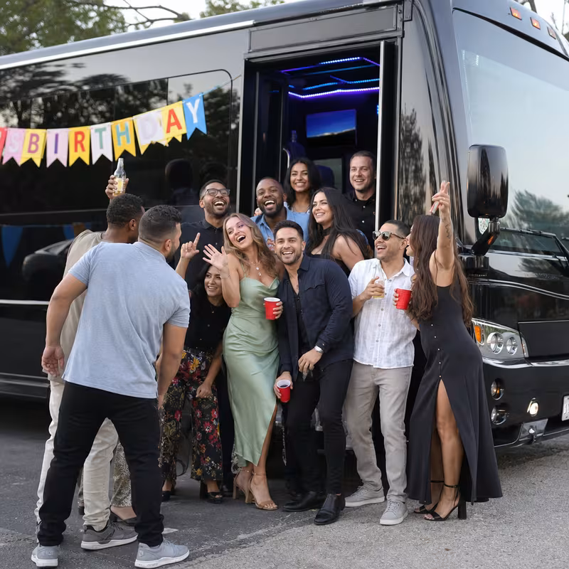 Group boarding a white charter bus for Birthday Transportation transportation in Washington
