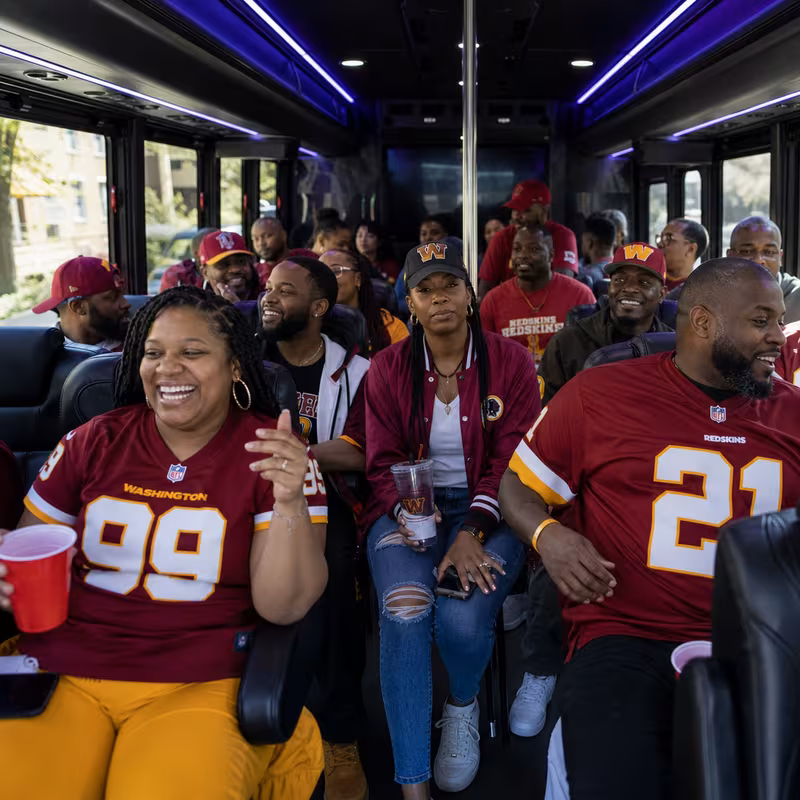 Group boarding a white charter bus for Sporting Event Transportation transportation in Washington