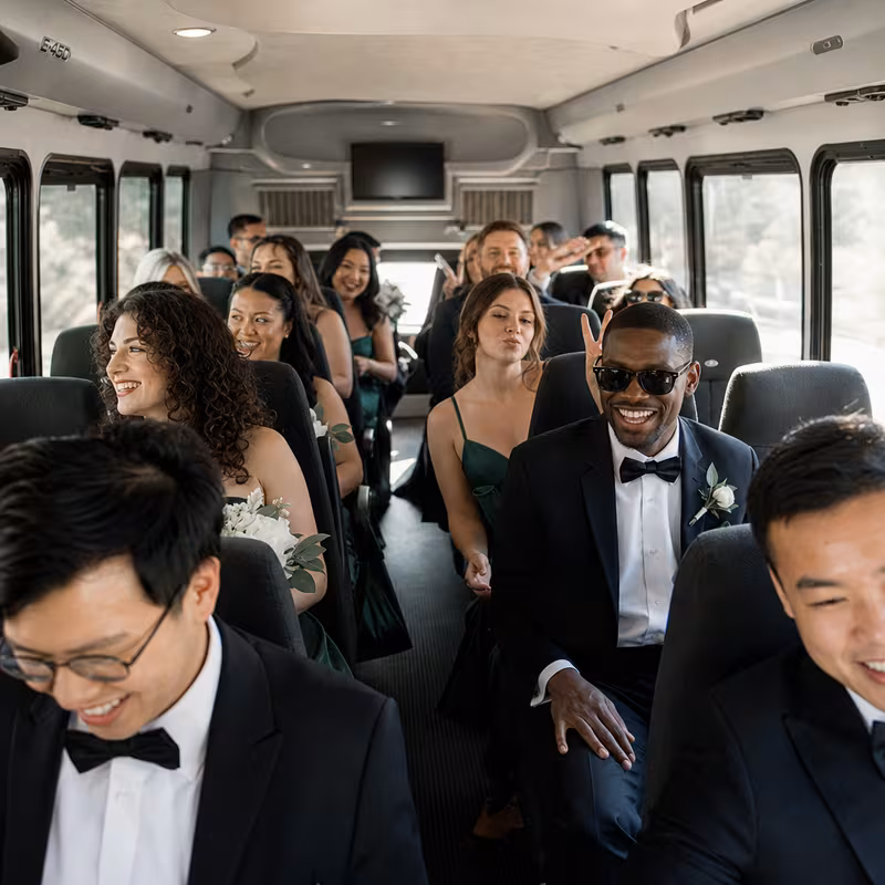 Group boarding a white charter bus for Wedding Transportation transportation in Washington