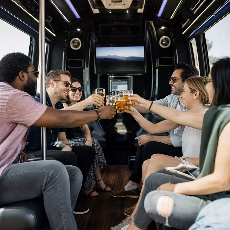 Group boarding a white charter bus for Winery & Brewery Tour Transportation transportation in Washington