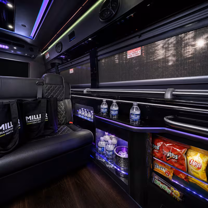 Party bus interior with wraparound leather seating and LED lighting in Washington